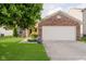 Brick home with a two-car garage, well-manicured lawn, and mature tree in the front yard at 16629 Greensboro Dr, Westfield, IN 46074