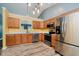 Spacious kitchen featuring stainless steel appliances, oak cabinets, and stylish pendant lighting at 16629 Greensboro Dr, Westfield, IN 46074