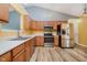 Kitchen with stainless steel appliances, oak cabinets, and modern lighting fixtures at 16629 Greensboro Dr, Westfield, IN 46074