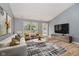Bright living room features new wood floors, modern decor, and large windows for natural light at 16629 Greensboro Dr, Westfield, IN 46074