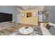 Open-concept living room featuring updated wood floors, yellow accent wall, and modern decor at 16629 Greensboro Dr, Westfield, IN 46074