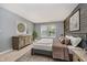 Comfortable bedroom with natural light, a wood accent wall, and modern furnishings at 16629 Greensboro Dr, Westfield, IN 46074