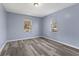 This bedroom features wood-look flooring and two windows for great natural light at 1739 N Alton Ave, Indianapolis, IN 46222