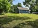 Quaint home with blue siding, brown roofing, a large backyard, and a lovely deck at 1810 N Parker Ave, Indianapolis, IN 46218