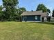 Quaint home with blue siding, brown roofing, a large backyard, and a lovely deck at 1810 N Parker Ave, Indianapolis, IN 46218