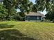 Quaint home with blue siding, brown roofing, a large backyard, and a lovely deck at 1810 N Parker Ave, Indianapolis, IN 46218