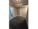 A carpeted bedroom has neutral walls and a doorway to a full bathroom with a vanity at 1810 N Parker Ave, Indianapolis, IN 46218