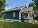 Quaint home with blue siding, brown roofing, and a lovely covered porch at 1810 N Parker Ave, Indianapolis, IN 46218