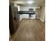A kitchen featuring stainless steel appliances, white cabinets, and black countertops is well-lit and spacious at 1810 N Parker Ave, Indianapolis, IN 46218