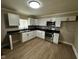 Bright kitchen with stainless steel appliances, white cabinetry, and modern backsplash at 1810 N Parker Ave, Indianapolis, IN 46218