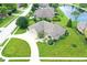An aerial view displays the home with well-maintained landscaping, pond, and a three-car garage at 182 Southwind Ln, Greenwood, IN 46142