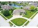 A beautiful aerial view of a brick home that features a pond, large yard, and three-car garage at 182 Southwind Ln, Greenwood, IN 46142