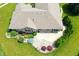 Aerial view of a home with a well-maintained roof, stone patio, and lush landscaping at 182 Southwind Ln, Greenwood, IN 46142