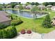 The backyard is an aerial view of a pond with fountain, lush green landscaping, and decorative arbor at 182 Southwind Ln, Greenwood, IN 46142