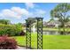 The backyard features a tranquil pond with a fountain, lush greenery, and a decorative arbor at 182 Southwind Ln, Greenwood, IN 46142