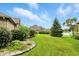 Landscaped backyard with green lawn, decorative rocks, and a pond at 182 Southwind Ln, Greenwood, IN 46142
