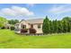 Backyard featuring stone terrace with green evergreens and manicured landscaping at 182 Southwind Ln, Greenwood, IN 46142
