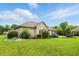 Large backyard with a lush lawn and manicured bushes at 182 Southwind Ln, Greenwood, IN 46142