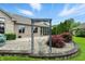 Stone path leading to a covered patio with landscaped garden and red Japanese Maple trees at 182 Southwind Ln, Greenwood, IN 46142