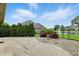 Concrete patio overlooking a landscaped backyard with red Japanese Maple trees and water feature at 182 Southwind Ln, Greenwood, IN 46142