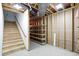 Stairwell leading to the basement features open stud bay, offering potential customization and storage at 182 Southwind Ln, Greenwood, IN 46142
