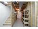 Basement stairwell, showing open stud bay and utility infrastructure, offering storage at 182 Southwind Ln, Greenwood, IN 46142