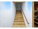 Stairwell leading to the basement with wood stairs and white walls, showcasing the home's utility access at 182 Southwind Ln, Greenwood, IN 46142