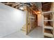Basement stairwell features open stud bays and utility infrastructure, suitable for storage at 182 Southwind Ln, Greenwood, IN 46142
