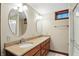 This bathroom features double sinks with granite counters and is brightly illuminated with vanity lighting at 182 Southwind Ln, Greenwood, IN 46142
