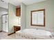 Primary bathroom featuring a soaking tub, shower with glass door, and vanity area with a well-lit mirror at 182 Southwind Ln, Greenwood, IN 46142