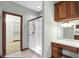 Bathroom featuring a glass enclosed shower, vanity with storage and view into large walk-in closet at 182 Southwind Ln, Greenwood, IN 46142
