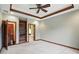 Spacious bedroom featuring plush carpeting, custom built-ins, and a decorative tray ceiling with a fan at 182 Southwind Ln, Greenwood, IN 46142