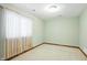 This bedroom has light green walls, plush carpet, and a large window with curtains for a cozy feel at 182 Southwind Ln, Greenwood, IN 46142