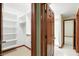 The walk-in closet offers a look into the bathroom with a shower behind the open door at 182 Southwind Ln, Greenwood, IN 46142