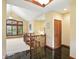 Bright foyer with a staircase, black tile flooring, and a large window with plantation shutters at 182 Southwind Ln, Greenwood, IN 46142