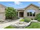 A charming brick home with a well-manicured lawn, stone planter and arched window at 182 Southwind Ln, Greenwood, IN 46142