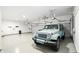 Wide angle shot of a garage and an aqua colored jeep at 182 Southwind Ln, Greenwood, IN 46142