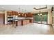 Spacious kitchen with dark wood cabinets, stainless steel appliances, island and sliding glass doors at 182 Southwind Ln, Greenwood, IN 46142