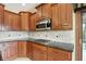 Well-equipped kitchen features stainless steel appliances, tile backsplash, and wood cabinetry at 182 Southwind Ln, Greenwood, IN 46142