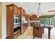 Bright kitchen featuring stainless steel appliances, dark wood cabinetry, and an island with seating at 182 Southwind Ln, Greenwood, IN 46142