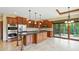 Open concept kitchen with stainless appliances, island, and sliding glass doors to the backyard at 182 Southwind Ln, Greenwood, IN 46142