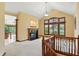 Open living room with a fireplace, large windows with shutters, and a view of the backyard at 182 Southwind Ln, Greenwood, IN 46142