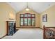 Open living room featuring a fireplace, vaulted ceilings, and large windows with plantation shutters at 182 Southwind Ln, Greenwood, IN 46142