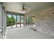 Enclosed sunroom with brick accent wall and windows showcasing view of the backyard at 182 Southwind Ln, Greenwood, IN 46142