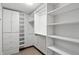 A walk-in closet with adjustable white shelving and ample storage space for clothes and accessories at 182 Southwind Ln, Greenwood, IN 46142