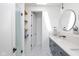 Bathroom featuring a glass shower, floating wood shelves, and marble countertops at 1905 N Alabama St, Indianapolis, IN 46202