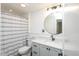 Well-lit bathroom with modern fixtures, a vanity, and a shower with a curtain at 1905 N Alabama St, Indianapolis, IN 46202