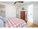 Bright bedroom with wooden floors, a ceiling fan, and an ensuite bath and closet at 1905 N Alabama St, Indianapolis, IN 46202