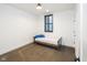 Minimalist bedroom featuring a single bed, a window with blinds, and a concrete floor at 1905 N Alabama St, Indianapolis, IN 46202