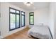 Sunny bedroom featuring wooden floors, ample light and bright white walls at 1905 N Alabama St, Indianapolis, IN 46202
